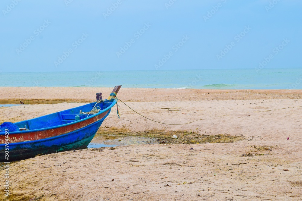 Blue color fishing boat on the beach