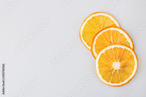 Eco organic homemade dried orange slices, chips. Dehydrated crispy fruit slices. Heap, pile of sun dried crunchy oranges. Healthy snack. Close up. Top view. Copy space