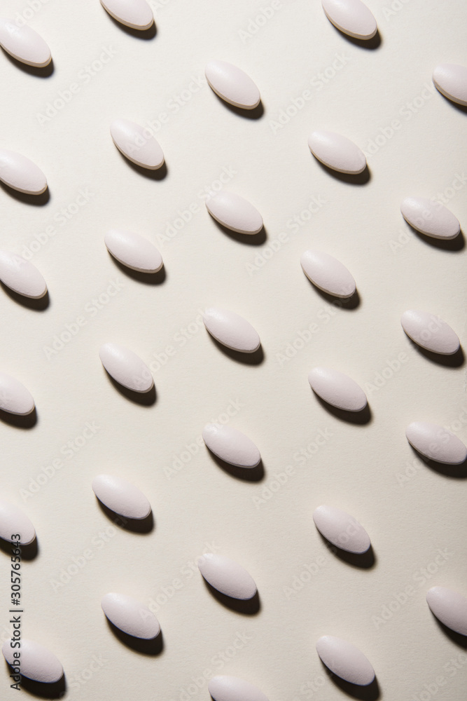 White pills linen pattern on white background. Healthcare and medical concept. White pills linen pattern on white background. Healthcare and medical concept.