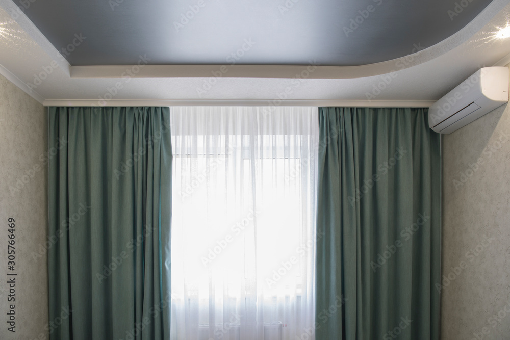 Apartment view with white suspended drywall ceiling with grey stretch ceiling and conditioner in apartment Apartment view with white suspended drywall ceiling with grey stretch ceiling and conditioner in apartment