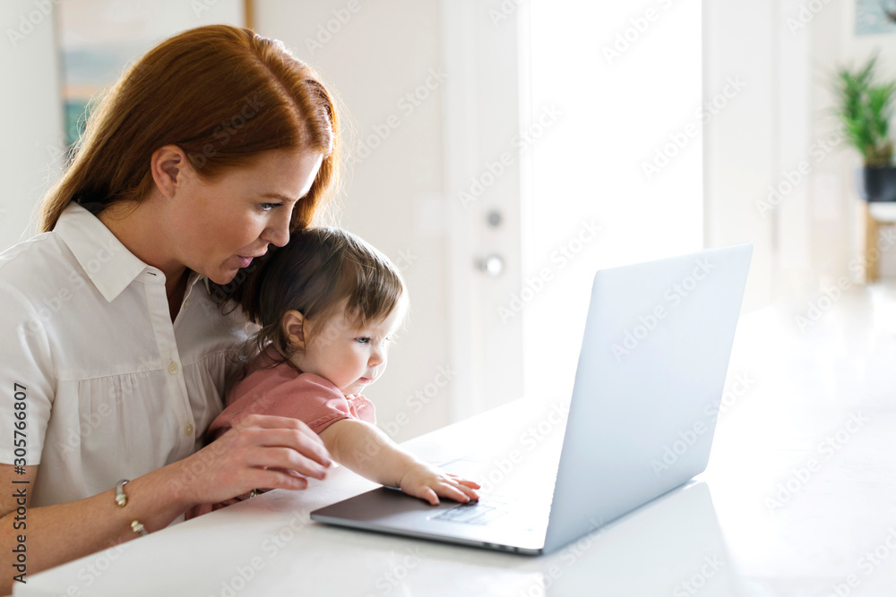 Mother and daughter using laptop Mother and daughter using laptop