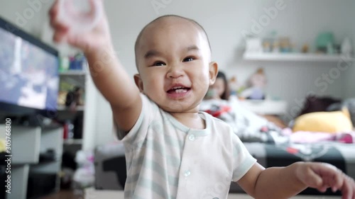 An infant follows the camera, the camera moves backwards.
