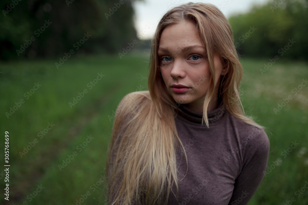 Portrait of young woman with blond hair in field Portrait of young woman with blond hair in field