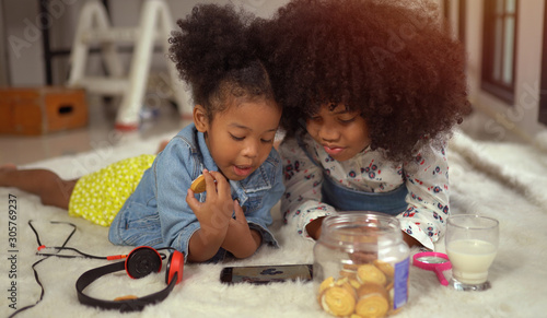 Afro children playing on smartphone