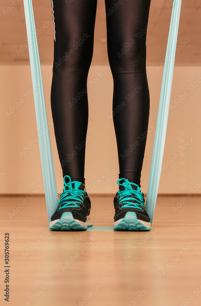 Stock photo of a young woman doing exercises with the resistance band Stock photo of a young woman doing exercises with the resistance band