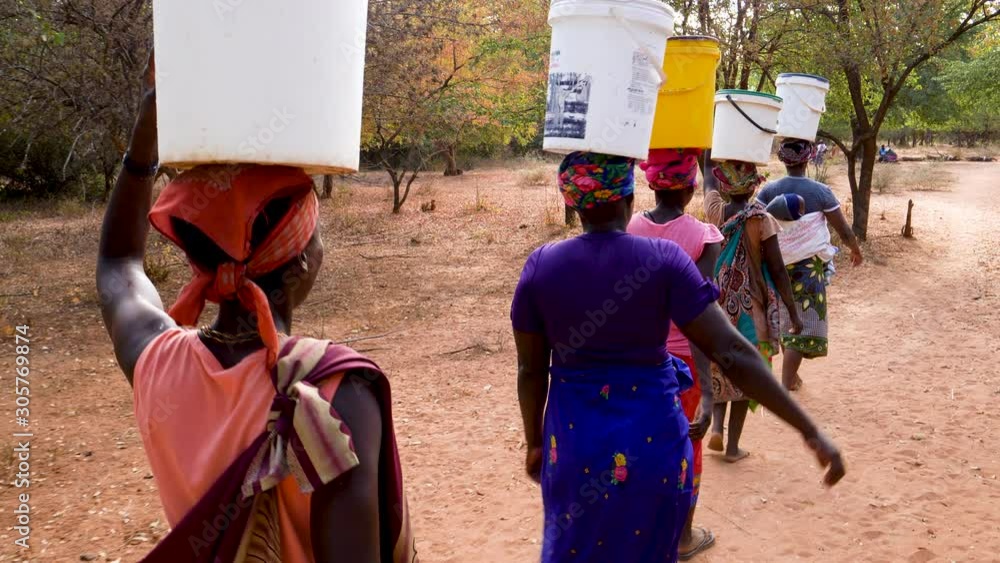 Water journey. Five woman and a baby make the long journey home carry