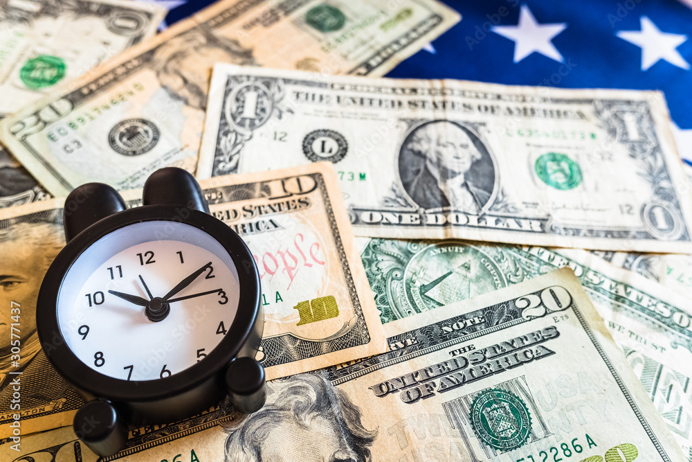 Alarm clock on dollar bills warning of the economic recession. Alarm clock on dollar bills warning of the economic recession.