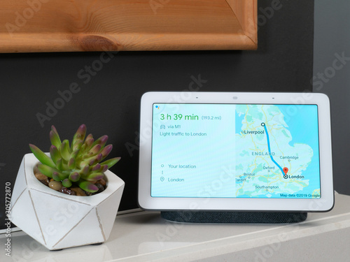 Smart home speaker in home setting showing travel directions