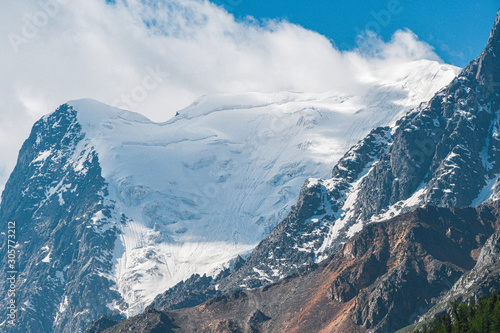 Fototapeta Naklejka Na Ścianę i Meble -  Snow cliffs under blue sky. Travel in  mountains