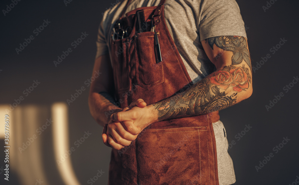 Fototapeta premium Crop barber clasping hands