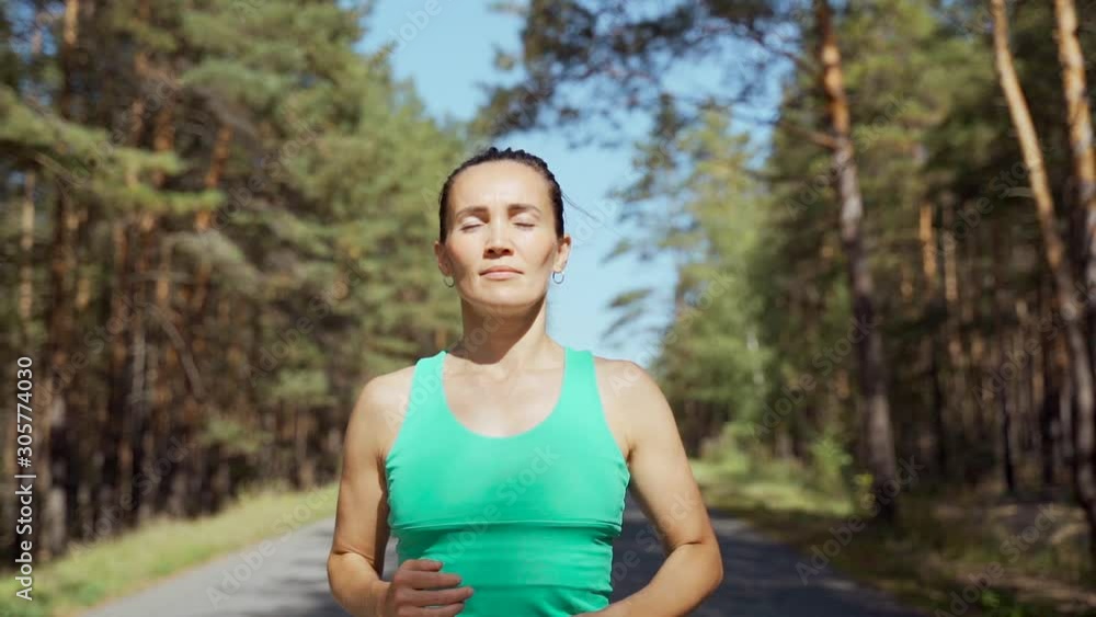 Girl athlete warming up before jogging. Jogging outdoors in the forest. Healthy lifestyle concept. Girl athlete warming up before jogging. Jogging outdoors in the forest. Healthy lifestyle concept.