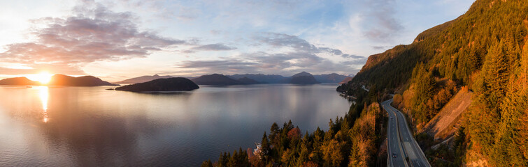 Sea to Sky Hwy in Howe Sound near Horseshoe Bay, West Vancouver, British Columbia, Canada. Aerial panoramic view during a colorful sunset in Fall Season.