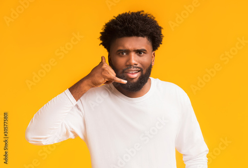 Single african guy making call me gesture