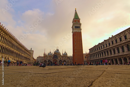 Venice, Italy-September 28,2019:Charmin landscape of famous San Marco Square. Low perspective view. St. Mark's Basilica with tower in the background. The most visited tourist attractions in Venice