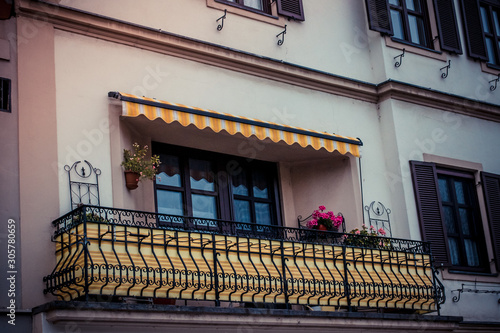 An old, beautiful balcony in a big city.