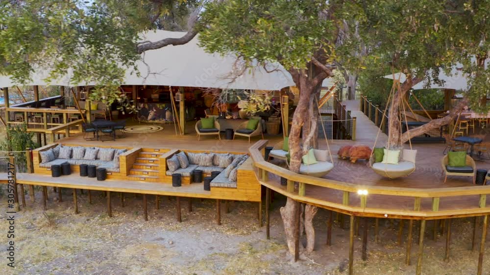 Close-up aerial panning view of the outside deck area and boma at Tuludi Safari Camp, Okavango Delta, Botswana Close-up aerial panning view of the outside deck area and boma at Tuludi Safari Camp, Okavango Delta, Botswana