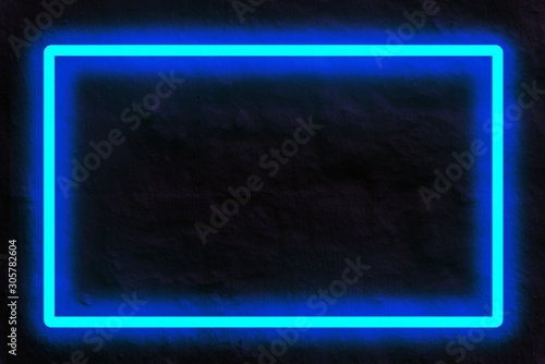 Fototapete blue neon light on a brick wall at night