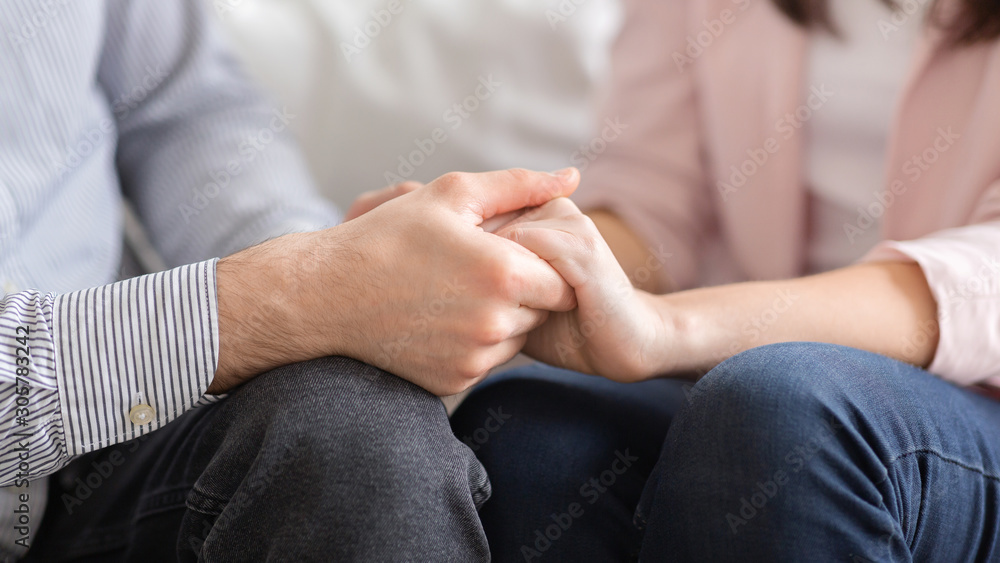 Man and woman holding hands, supporting each other Man and woman holding hands, supporting each other