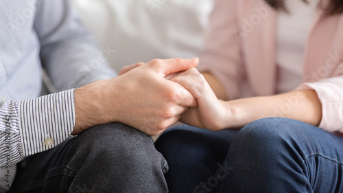 Man and woman holding hands, supporting each other