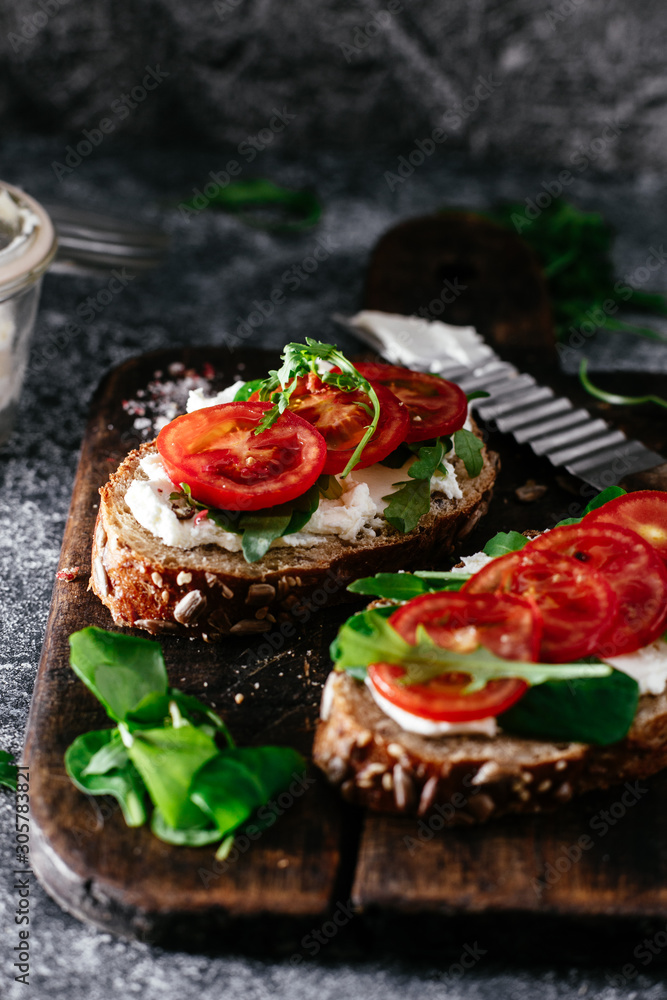 Whole grain bread bruschetta with cream cheese and cherry tomatoes Whole grain bread bruschetta with cream cheese and cherry tomatoes