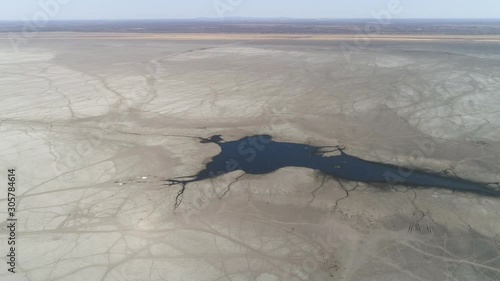 Climate change.High aerial panning view showing the level of devastation due to drought and climate change of what is left of these usually abundant waters of Lake Ngami, Okavango Delta, Botswana photo