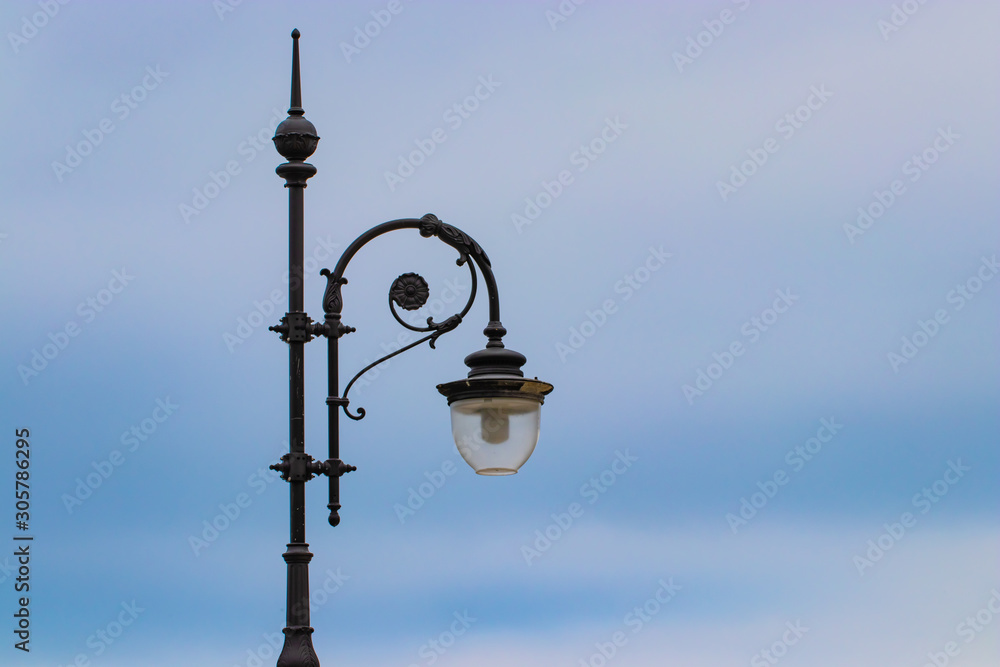 Silhouette of a street lamp against the blue sky Silhouette of a street lamp against the blue sky