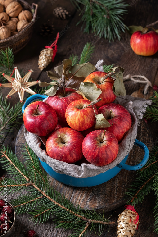Fresh apples with Christmas straw ornaments and spruce branches Fresh apples with Christmas straw ornaments and spruce branches