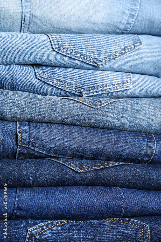 Stack of different jeans as background, closeup Stack of different jeans as background, closeup