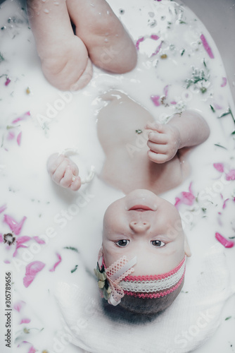 baby in milk with flowers