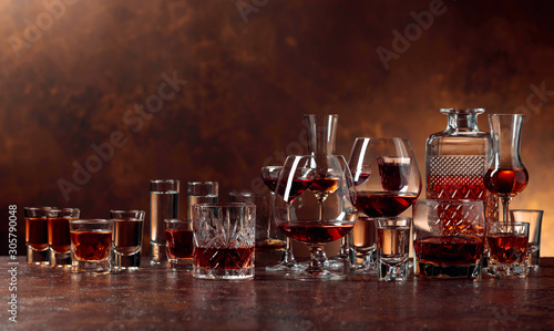 Bilde på lerret Set of strong alcoholic beverages in glasses on a brown background