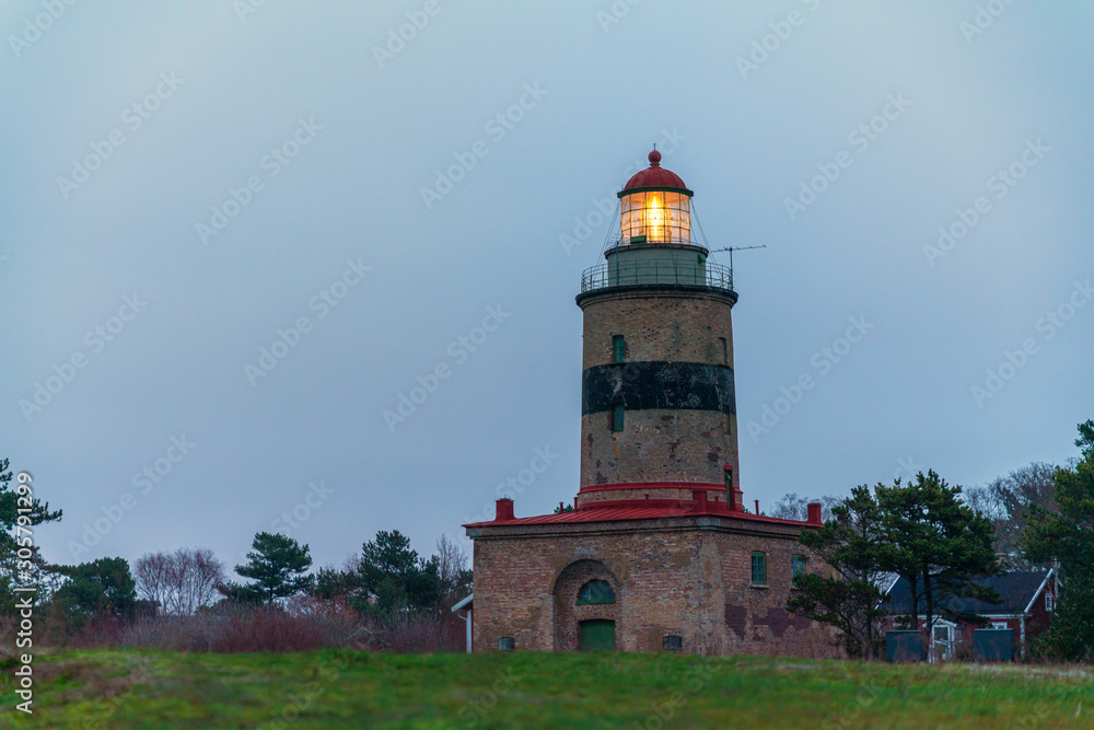 Falsterbo lighthouse in southern Sweden, built in 1796, still shines for the ships out in oresund in the evenings and nights between Sweden and Denmark