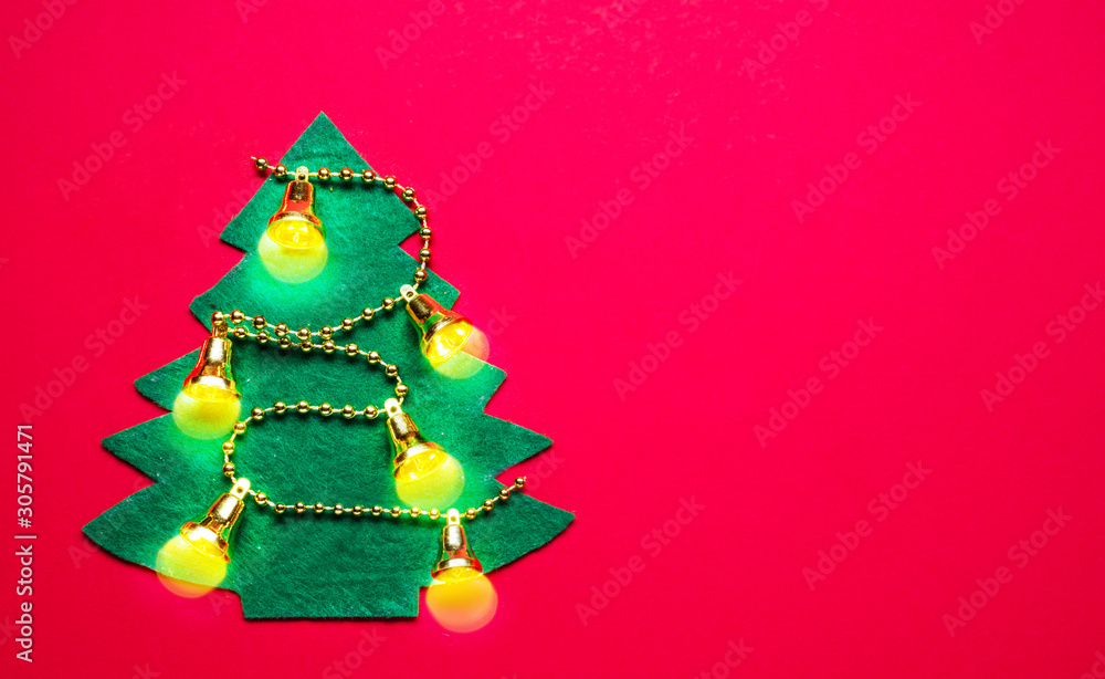 Handmade felt New Year Tree on red paper background. New Year or Christmas background. Handmade felt New Year Tree on red paper background. New Year or Christmas background.