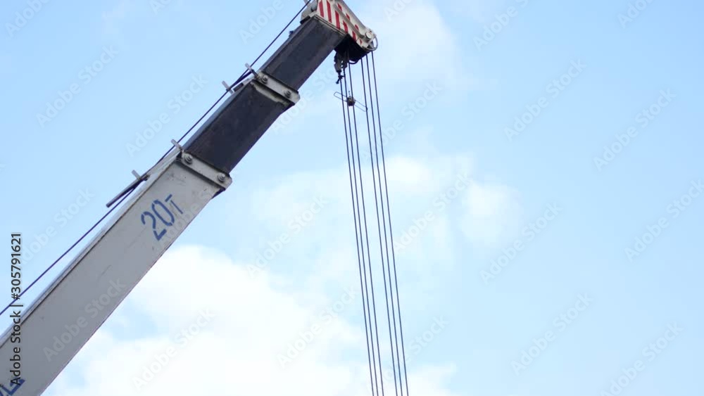 Crane against the sky at work, construction and reconstruction work Crane against the sky at work, construction and reconstruction work