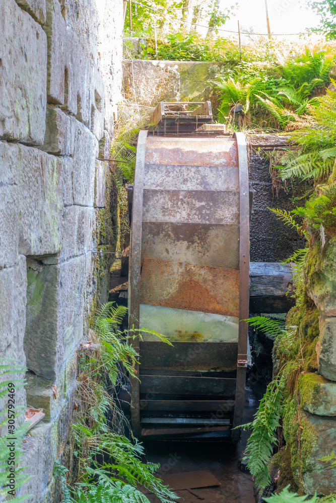Fototapeta premium Mélisey, France - 10 11 2019: The Baverey barns. Mill wheel