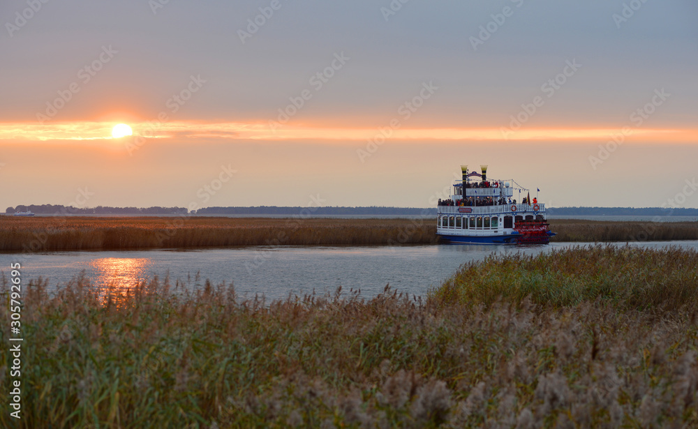 Zingst, Germany, a wheel paddle boat on the water in beautiful sunset