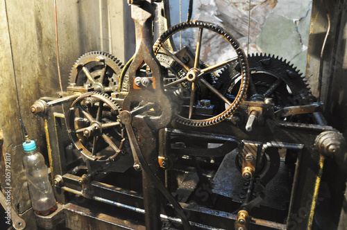 The mechanism of the old clock mounted on the town hall.