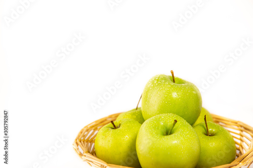 Apples in a fruit basket are good for a healthy diet in a white background.