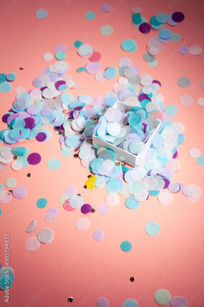 Pink background with color confetti in box, holiday