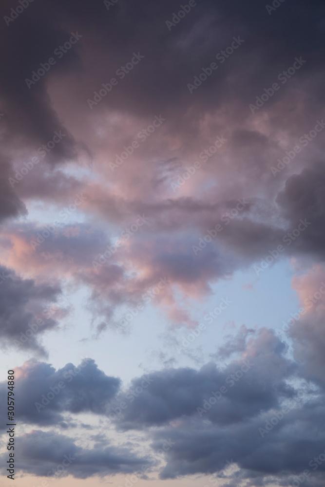 Amazing nature background: dramatic purple and blue cloudy sunset sky shot vertical.