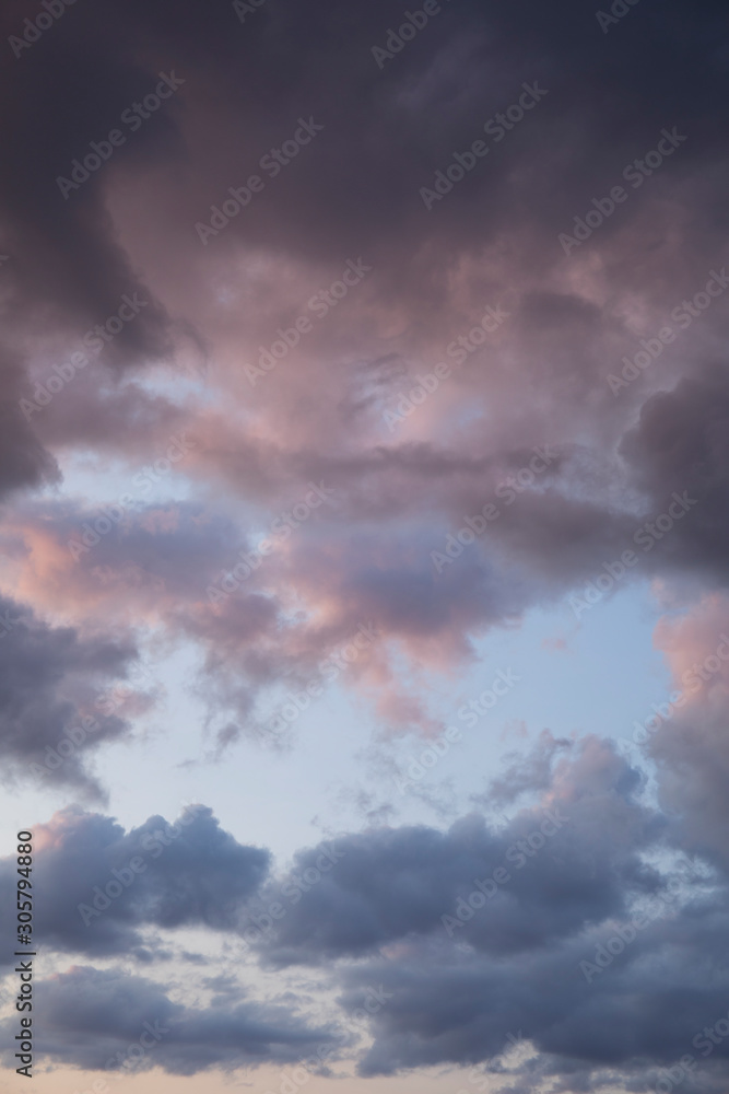 Amazing nature background: dramatic purple and blue cloudy sunset sky shot vertical. Amazing nature background: dramatic purple and blue cloudy sunset sky shot vertical.