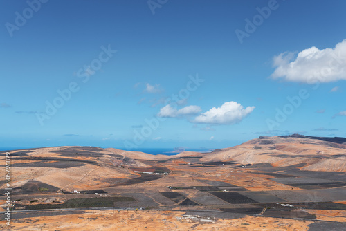 colorful scenic landscape on Lanzarote, Canary Islands, against ocean and blue sky