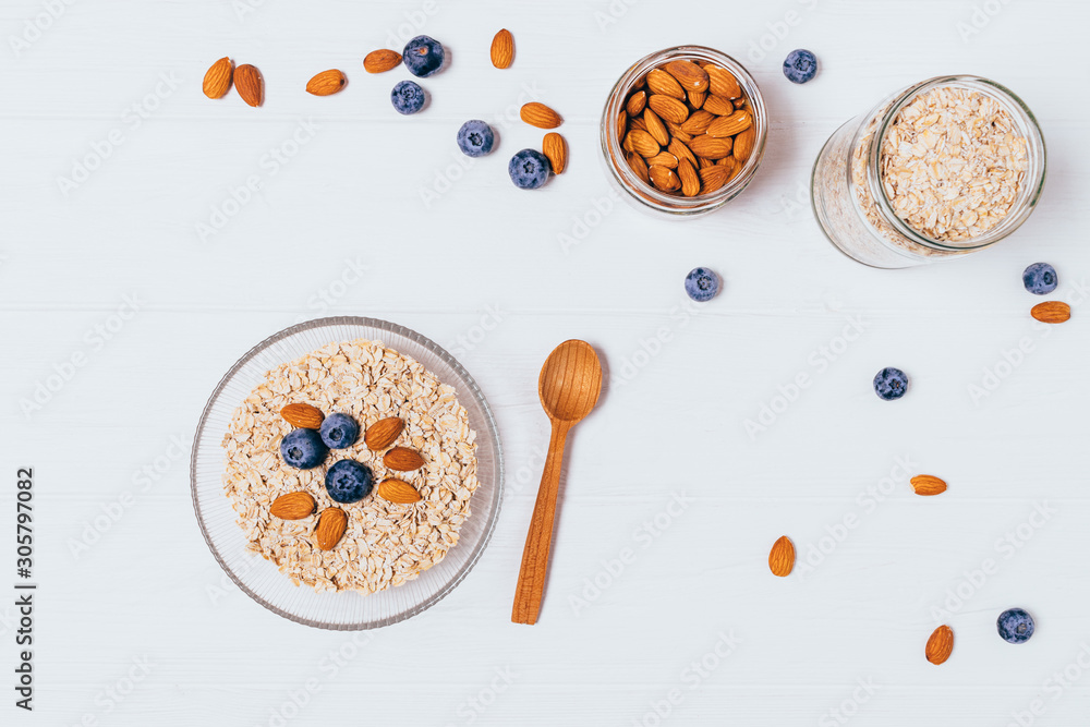 Bowl of oatmeal flakes, almonds and fresh blueberries Bowl of oatmeal flakes, almonds and fresh blueberries