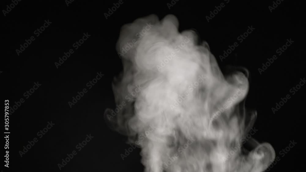 A stream of white steam or smoke close-up on a black background A stream of white steam or smoke close-up on a black background