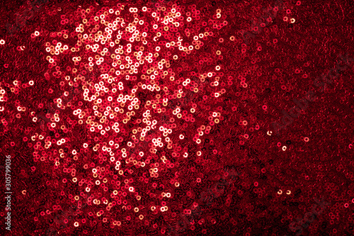 Red sequinned background . Holidays backgrounds and textures . Christmas and St. Valentine’s Day background.