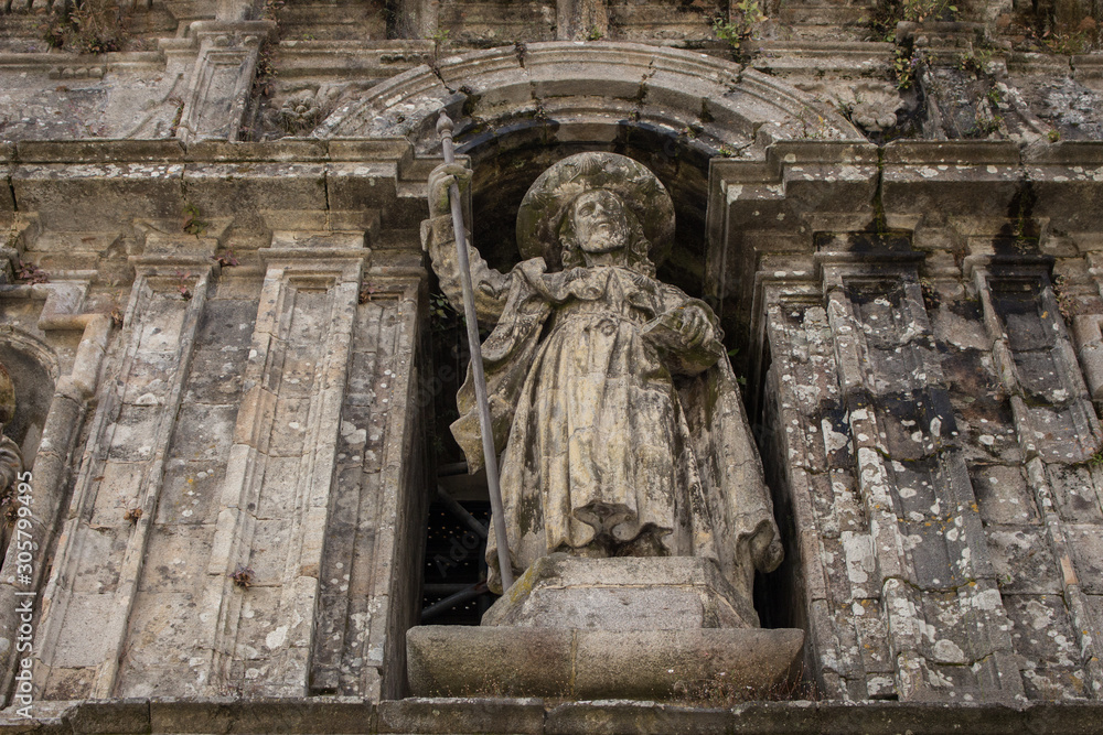 Santiago de Compostela, Spain - 10\13\2018: medieval statue of Saint Jacob at the church facade. Symbol of pilgrimage and travel. Monument of catholic saint James in Santiago de Compostela.
