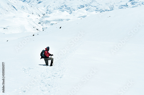 Mountain trekker struggling through the snowed landscape, Himalayas © Martin M303