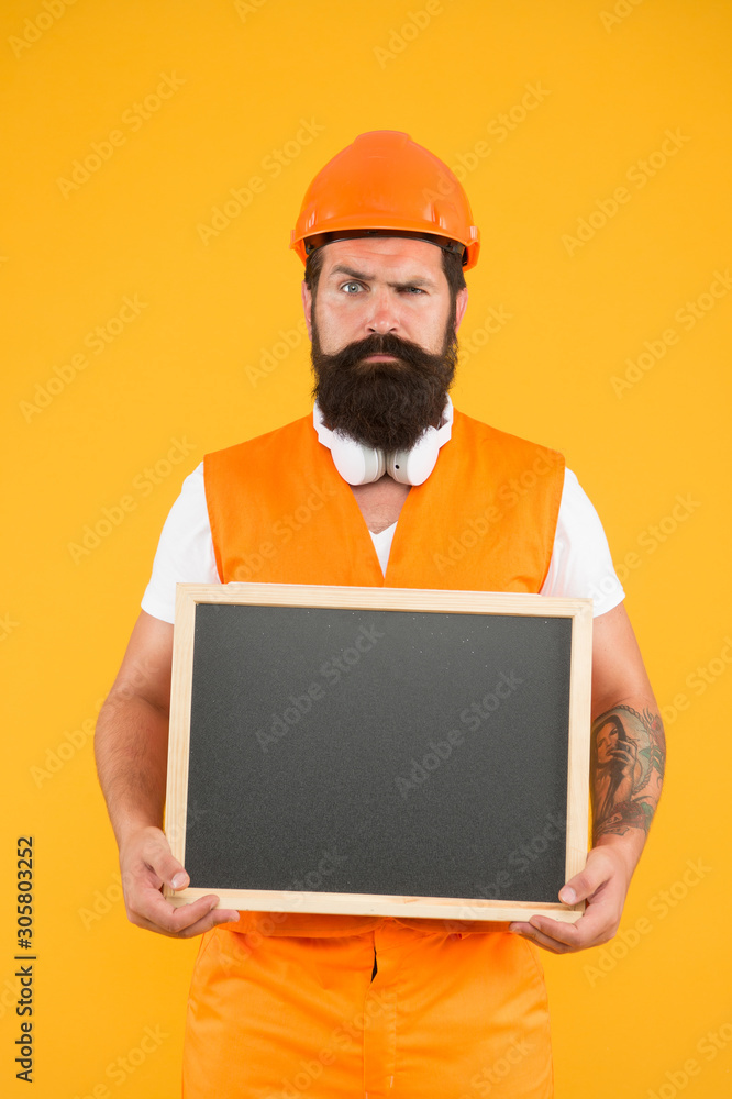 Repairman engineer hold blackboard copy space. Handsome repairman. Man bearded repairman builder work clothes. Plan repair work. Responsibility and guaranties. Engineering and architect occupation Repairman engineer hold blackboard copy space. Handsome repairman. Man bearded repairman builder work clothes. Plan repair work. Responsibility and guaranties. Engineering and architect occupation
