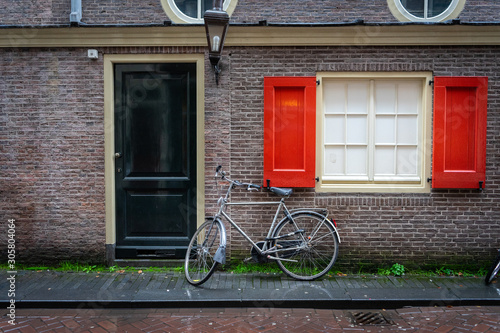 Traditional dutch bicycle parked on near brick wall in Amsterdam