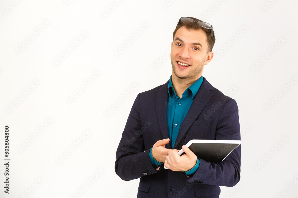 Smiling young man using tablet computer against a white background Smiling young man using tablet computer against a white background