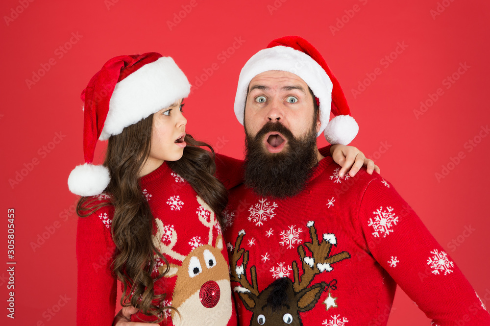 Weird things going on. Father and daughter winter sweaters celebrate new year. Happy family hug. Concentrated faces. Merry christmas. Bearded man and kid. Family celebrate holiday. Family tradition Weird things going on. Father and daughter winter sweaters celebrate new year. Happy family hug. Concentrated faces. Merry christmas. Bearded man and kid. Family celebrate holiday. Family tradition